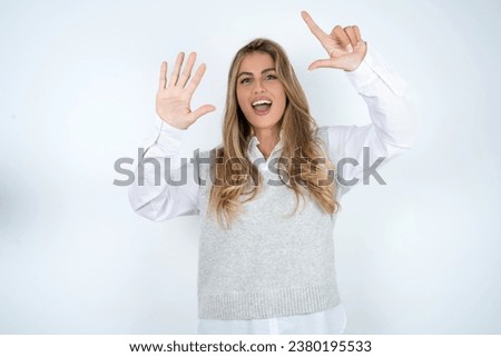 young beautiful woman showing and pointing up with fingers number seven while smiling confident and happy.