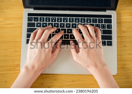 Photo top view of arms typing write code project management journalism profession use netbook keyboard isolated on desk background