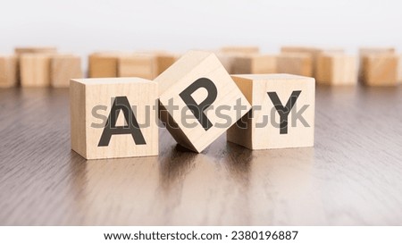 wooden cubes with text APY on gray table