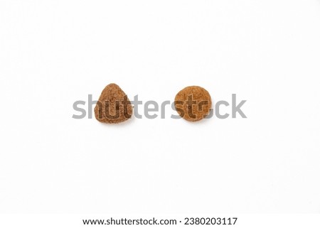 Pet food with Triangular and circular animal feed. Royalty-Free Stock Photo #2380203117