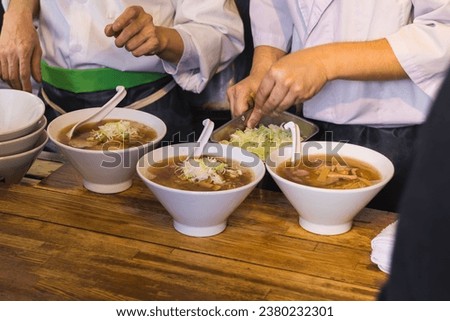 picture of Japanese chefs preparing traditional soups at a street kitchen in Tokyo, Japan
