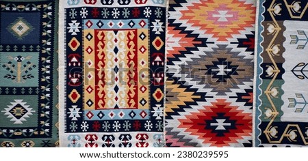 Carpets displayed for sale in a bazaar , patterns, texture. Royalty-Free Stock Photo #2380239595