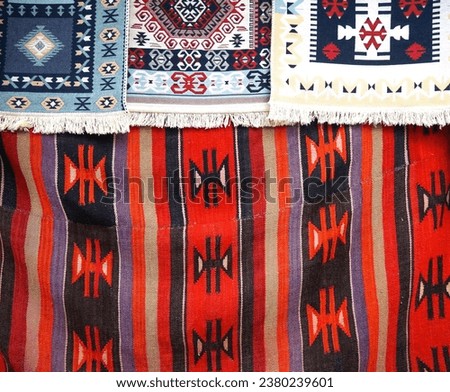 Carpets displayed for sale in a bazaar , patterns, texture. Royalty-Free Stock Photo #2380239601