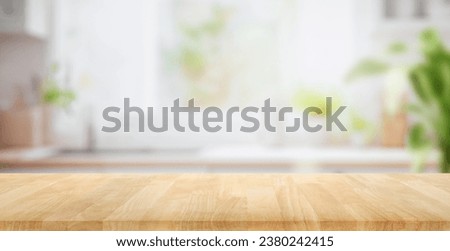 Selective focus.Wood table top on blur kitchen counter background.For montage product display or design key visual layout. Royalty-Free Stock Photo #2380242415