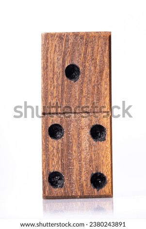 Domino tiles, handcrafted in wood, on white background, close-up