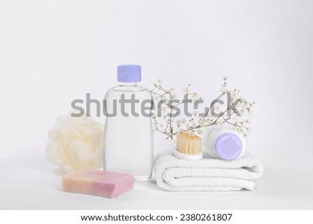 Different skin care products for baby in bottles, gypsophila and accessories on white background Royalty-Free Stock Photo #2380261807