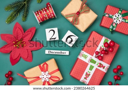 Gift boxes, wooden calendar with date December 26 on green background Boxing Day occurs annually on December 26 (day after Christmas ). In 2023, Boxing Day falls on Tuesday, December 26 Xmas day Royalty-Free Stock Photo #2380264625