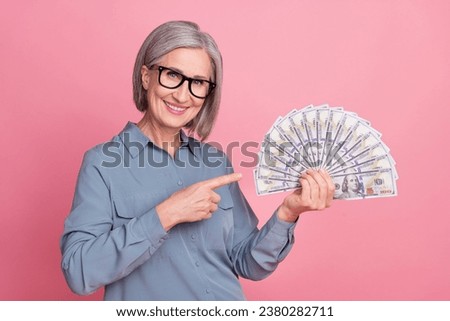 Photo of charming successful retired lady stylish clothes demonstrate credit bank salary savings isolated on pink color background