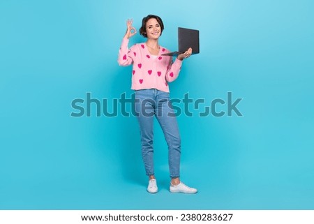 Full body photo of young woman wear pink cardigan print strawberry style show okey symbol laptop good job isolated on blue color background