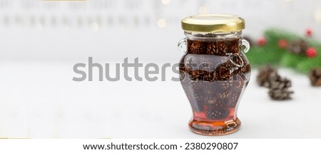 Banner with young pine cones jam in glass bowl. Delicious jam with the little pine cones. Royalty-Free Stock Photo #2380290807