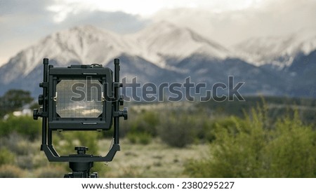 Analong 4x5 film camera in the mountains; landscape film photography viewfinder