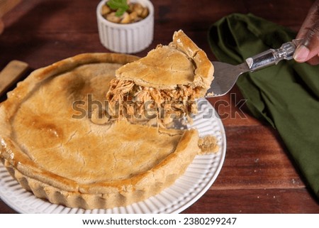 slice of chicken pie on rustic wooden background Royalty-Free Stock Photo #2380299247