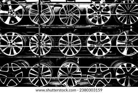 Stainless auto metal wheel frames displayed on the shelves, abstract shapes and geometry of circular metallic objects, monochromatic photo