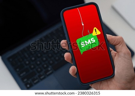 Smishing concept on a smartphone screen, text message scam Royalty-Free Stock Photo #2380326315