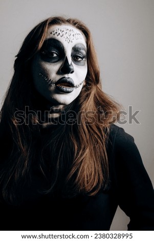 Girl with Halloween style makeup posing for camera