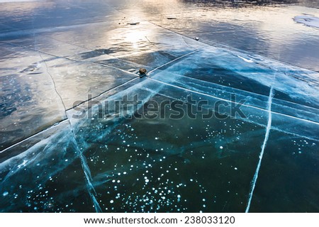 Natural ice on the lake. Beautiful winter landscape