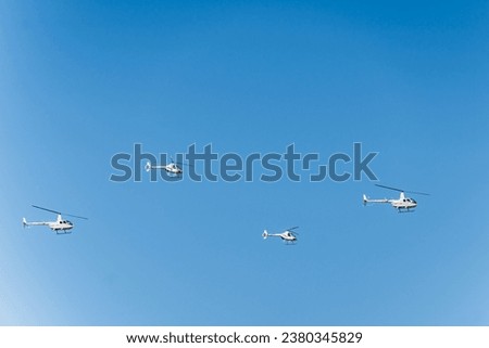 Group combat helicopters, aerobatic team performs flight at air show. Military vehicles used in the army agains blue sky. High quality photo
