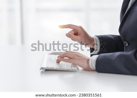 Business asian female professionals worker using computer keyboard diving into digital tasks, showcasing dedication and finesse, all from their workstations, cloud computing. Royalty-Free Stock Photo #2380351561