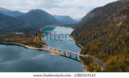 Aerial drone view of Faller-Klamm-Brucke bridge over Silvenstein lake, Karwendel mountain range Alps, Upper Bavaria, Germany in auttumn