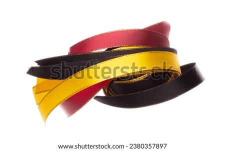 Black gold red ribbon long straight fly in air with curve roll shiny. Black gold red ribbon for present gift birthday party to wrap around decorate and curve long straight. White background isolated
