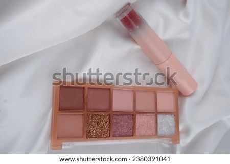 Lipstick adds color to the lips, while eyeshadow enhances the eyelids with various shades.