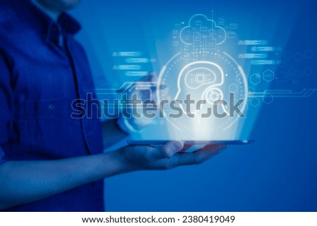 Man holding a tablet with a virtual display screen showcasing the artificial intelligence (AI), innovation and automation with AI prompts and chat assistant capabilities on display Royalty-Free Stock Photo #2380419049
