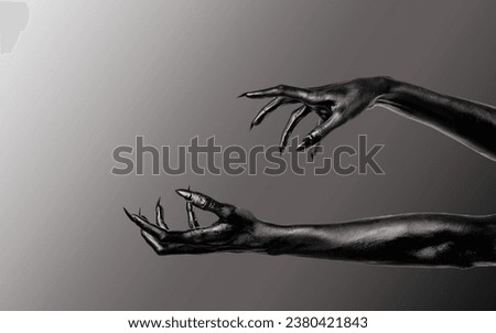 Black Devil Creepy Scary Monster Halloween Hand isolated on a grey background. Concept of murder. Horror Scene with zombie Hand. closeup Black Hands with Long Nails death. monster claw. Copy space. Royalty-Free Stock Photo #2380421843