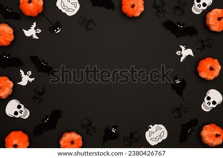 Layout of Halloween decorations on a black background:pumpkins,bats,spiders,skulls,ghosts.Halloween concept. Flat lay.