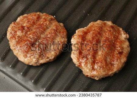 Tasty hamburger patties on grill pan, closeup