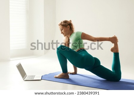 girl doing morning exercises and stretching online on a white background, online fitness training