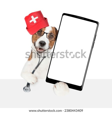 Smart jack russell terrier wearing like a doctor with stethoscope on his neck showing big smartphone with white blank screen in it paw above empty white banner. isolated on white background