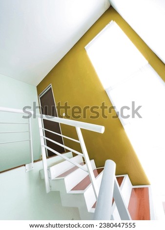 A staircase with iron framework painted neatly and wood-floored