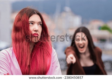angry women screaming enraged arguing on the street Royalty-Free Stock Photo #2380450857