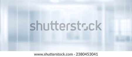 Beautiful light blue blurred background image of a modern office or hospital through frosted glass.