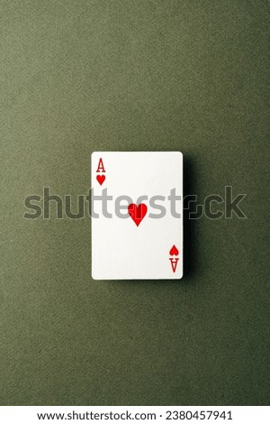 Ace playing card on green background close up