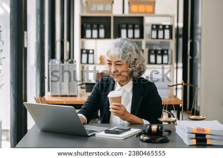asian woman lawyer working and gavel, tablet, laptop in front, Advice justice and law concept. in office
