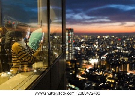 Woman take photo inside building terrace at night