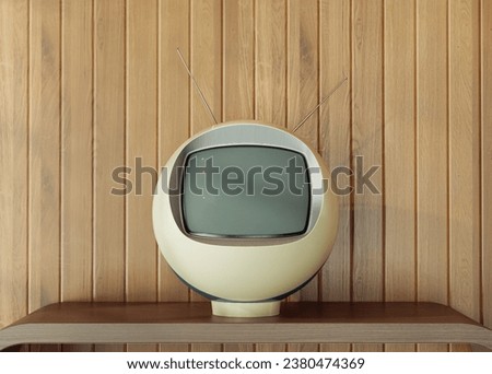 A sphere shaped vintage retro television from the futurism seventies on a stand in a dated wooden seventies backdrop - 3D render