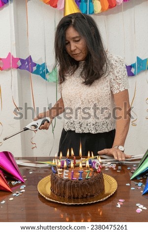 Woman lighting candles to celebrate her birthday. My Real Holiday