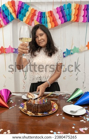 A woman raises her glass of wine to toast her birthday. My Real Holiday
