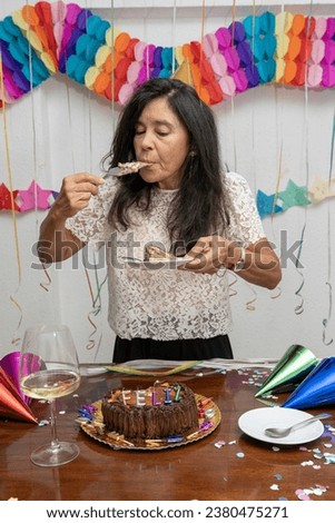 A woman eats a slice of cake on her birthday. My Real Holiday