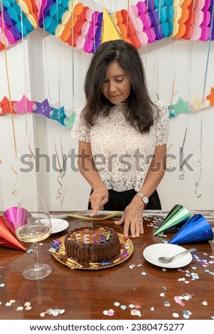A happy woman breaking a slice of cake on her birthday. My Real Holiday