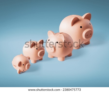 Many piggy banks in a row: financial growth and earning concept