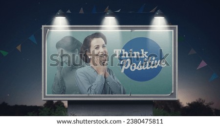 Happy woman with positive mood on billboard advertisement and motivational quote: think positive