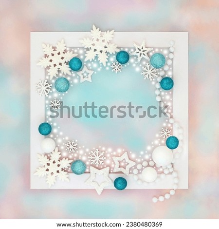 Fantasy Christmas white snowflake star and ball decorations with abstract snow on white frame on rainbow sky background. Magical North pole theme for holiday season.