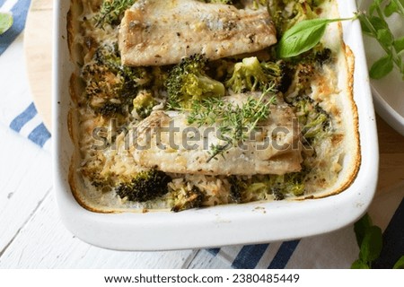 Fish bake with rice and broccoli in a casserole dish