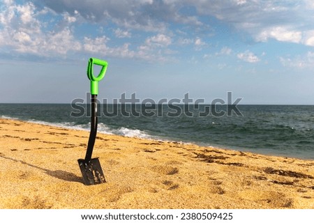Car shovel for SUVs in the sand on the seashore. Terraforming a sandy beach. Coastal change Royalty-Free Stock Photo #2380509425