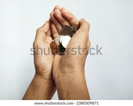 Both hands were holding the coins as if they were the most valuable thing. Royalty-Free Stock Photo #2380509871