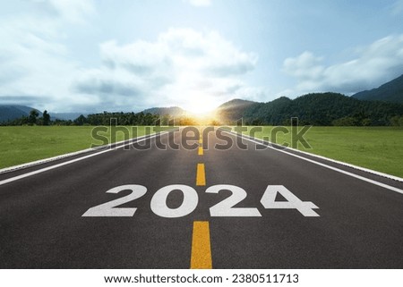The word Happy New Year 2024 or Start 2024 on the road or highway with a sunrise or sunset background. for forward to the goal. Concept of planning, challenge, new year resolution.