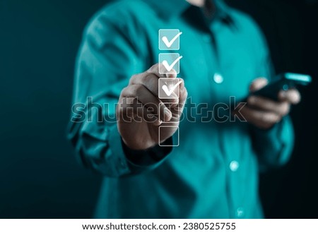 Businessman showing check mark summarizing job Compile lists, votes, and to-do lists. Checklists, task lists, and summaries description checklist Documents and online quality assessment standards
 Royalty-Free Stock Photo #2380525755
